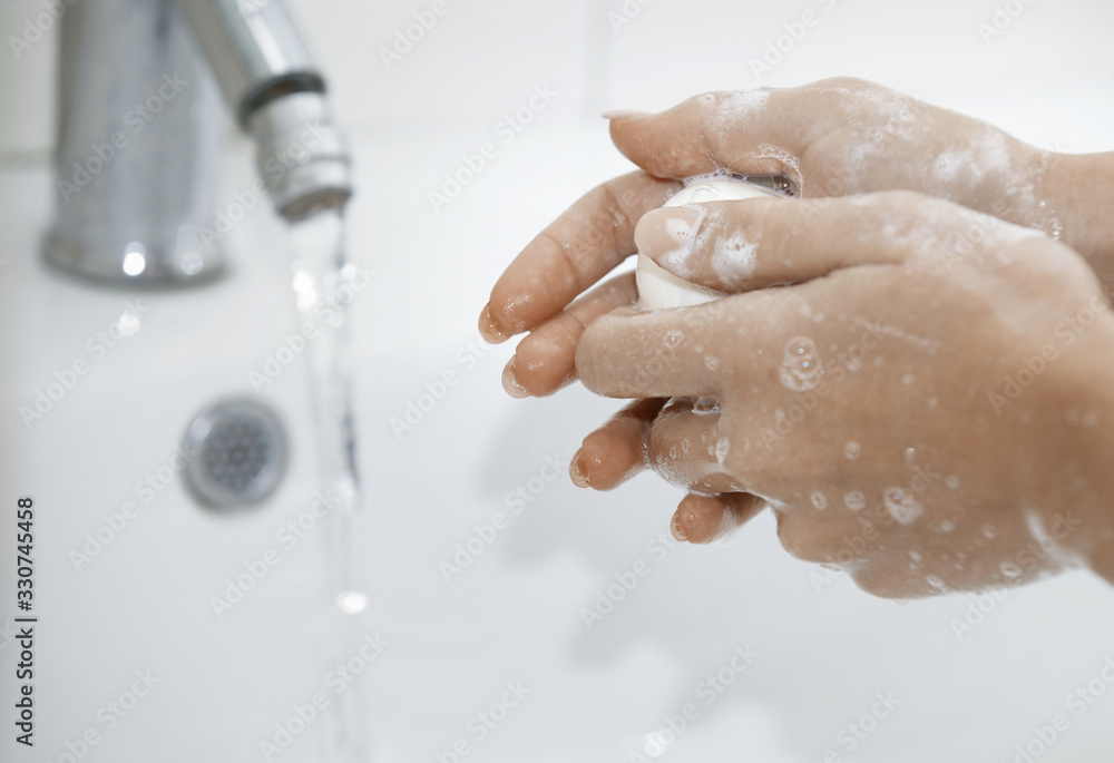 Fototapeta premium Woman washing hands with soap
