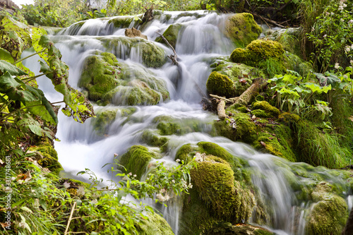 Long exposure waterfall with green fresh moss 