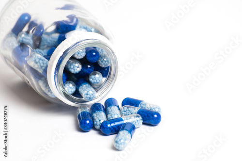 Cans with pills scattered on a white background. Medicine concept and protection against coronavirus