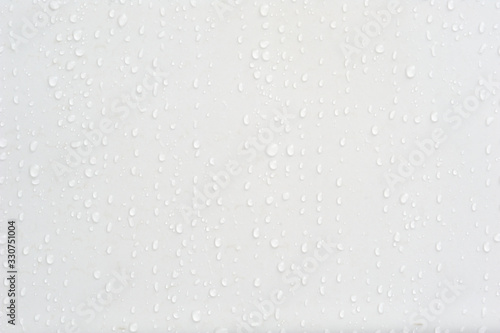 Beautiful water drops at a clean wall in difference sizes from small ones to big ones nice and perfect background for many occasions