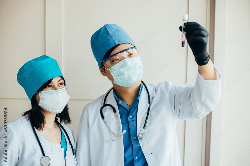 Asian doctors holding blood test. Covid-19 Asian doctors holding blood test. Covid-19