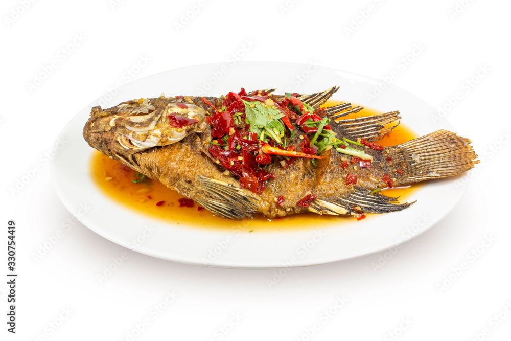 Whole Fried Fish Topped With Sweet Chili three flavors in a white bowl, Thai food.