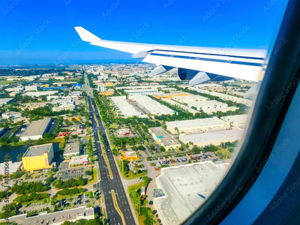 Miami from airplane porthole at day with blue sky