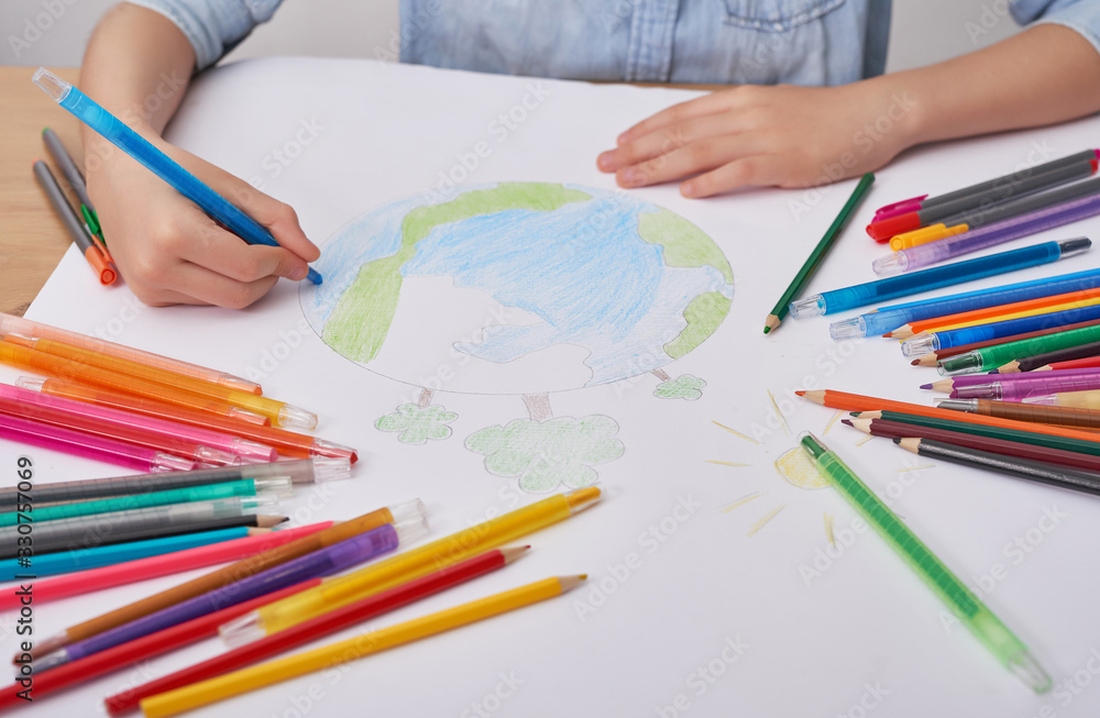 Child boy draws planet for earth day. Protection of enviroment, Mother Earth Day greeting and celebration. Save our planet! Concept of art learning and education, love earth , save world and unity Child boy draws planet for earth day. Protection of enviroment, Mother Earth Day greeting and celebration. Save our planet! Concept of art learning and education, love earth , save world and unity