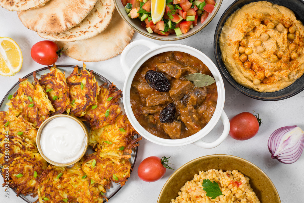 Israeli cuisine: esik fleisch - beef stew with damson plums and spices, hummus, potato latkes, ptitim, a type of pasta also known as Israeli cuisine: esik fleisch - beef stew with damson plums and spices, hummus, potato latkes, ptitim, a type of pasta also known as