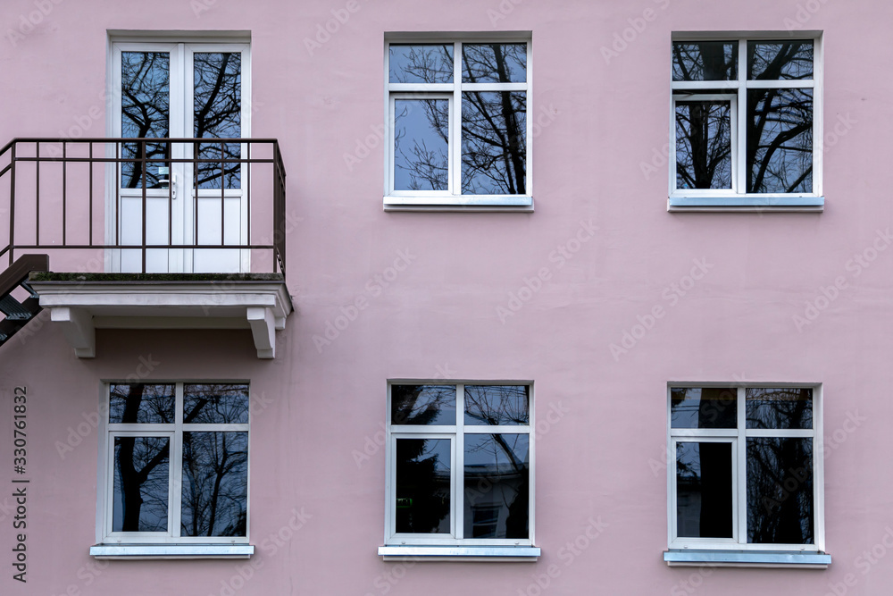 Wall of a residential building with closed windows and old stucco House Exterior Details in Estonia