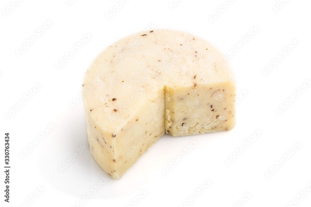 Piece of cheddar cheese isolated on white background. Side view.