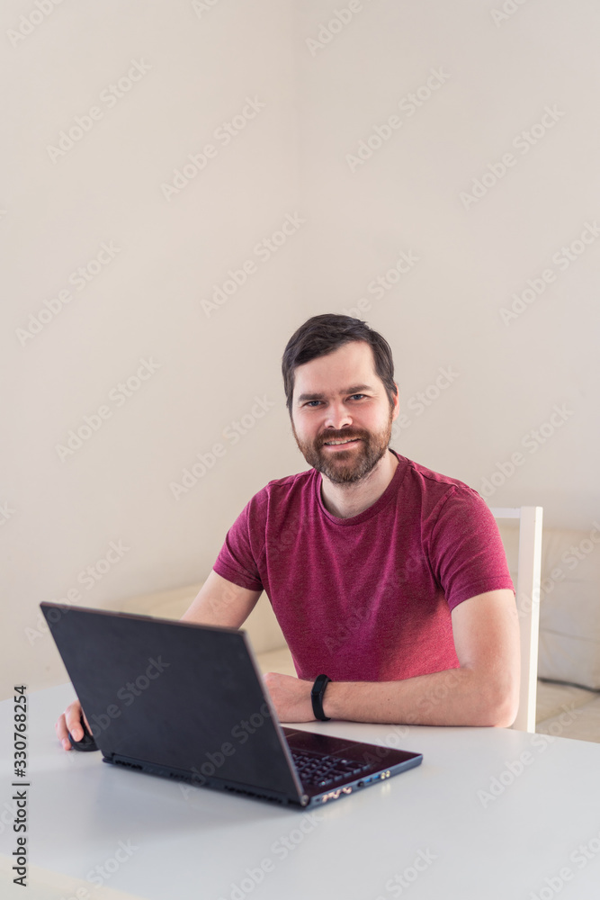 Men remote work from home behind laptop during epidemic in quarantine Men remote work from home behind laptop during epidemic in quarantine