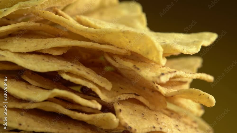 Corn chips on a plate close-up. Snacks shot in studio lighting. Corn chips on a plate close-up. Snacks shot in studio lighting.