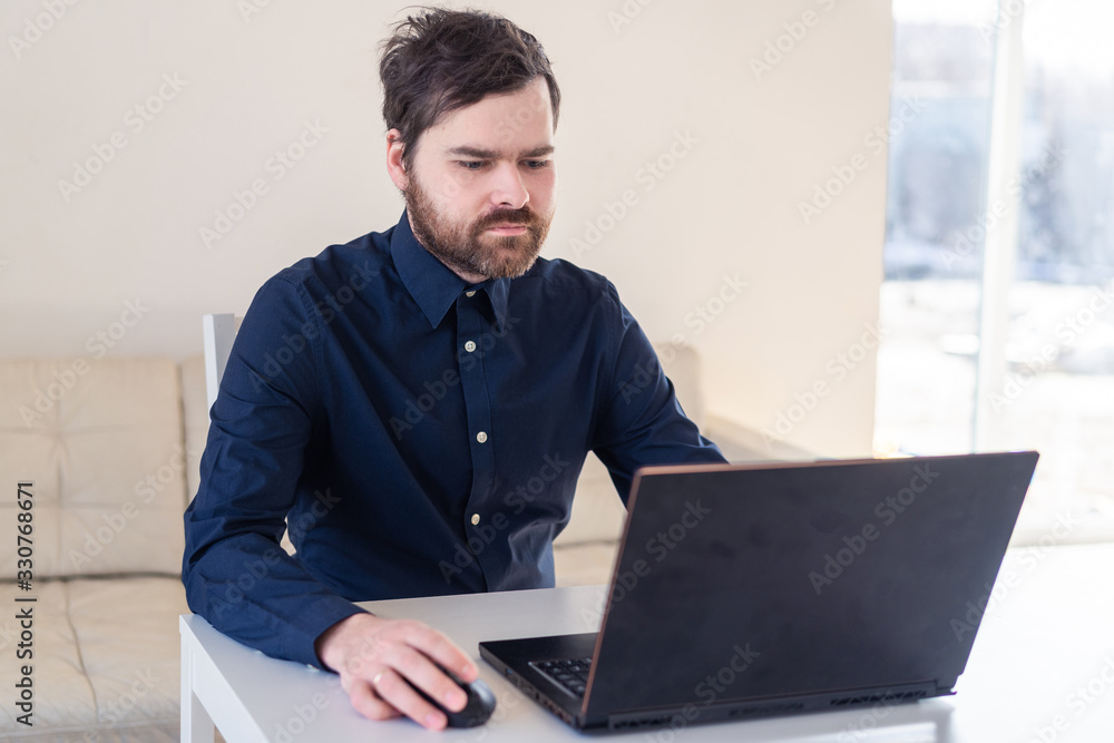 Men remote work from home behind laptop during epidemic in quarantine Men remote work from home behind laptop during epidemic in quarantine