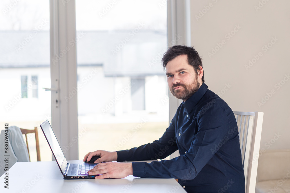Men remote work from home behind laptop during epidemic in quarantine Men remote work from home behind laptop during epidemic in quarantine