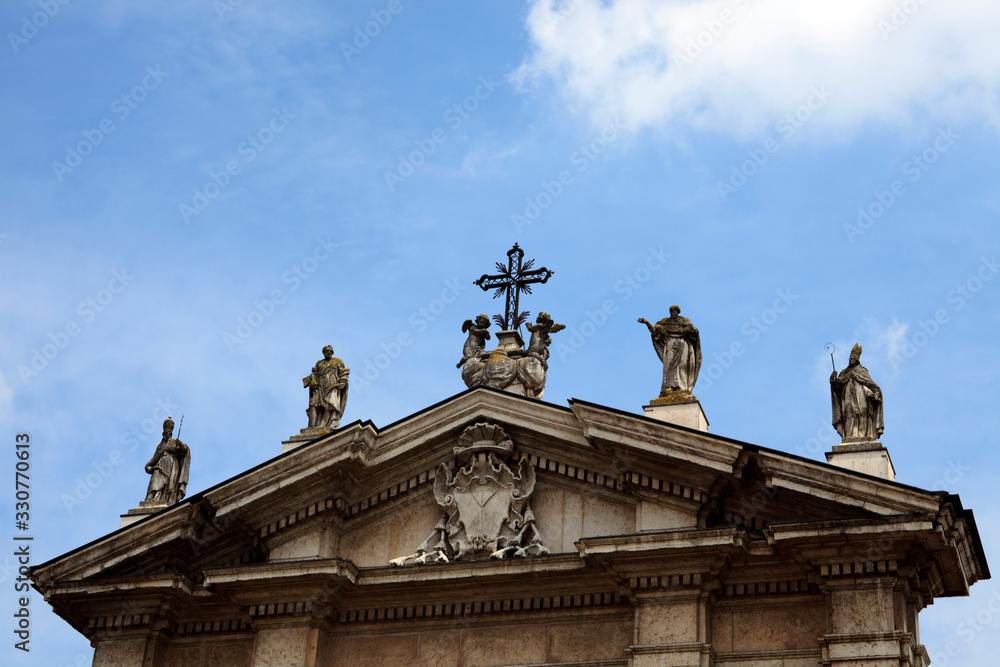 Mantova (MN), Italy - June 10, 2017: Baroque style Carrara marble facade and Gothic bell tower, Cathedral of Saint Peter the Apostle, Piazza Sordello, Mantova, Lombardy, Italy