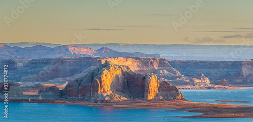 The morning light striking the cliffs of Utah’s Grand Staircase-Escalante National Monument with Lake Powell in the foreground.