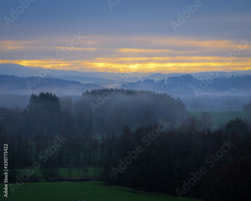 Foggy and cloudy sunrise in the countryside