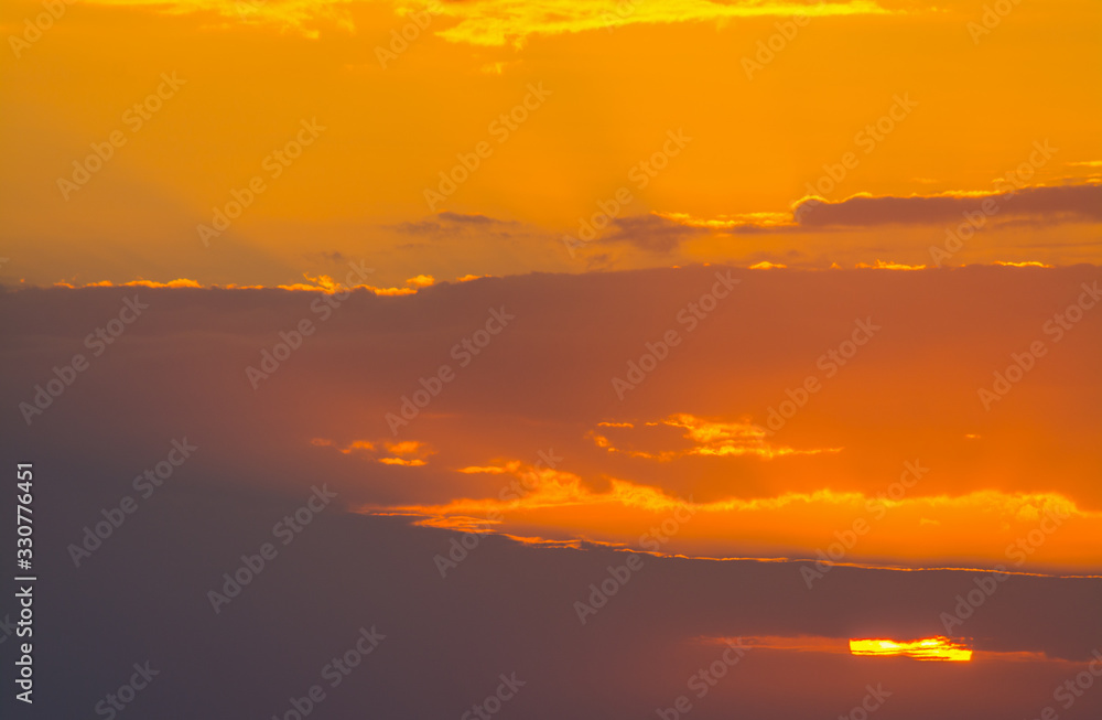 Dark clouds and orange sky at sunset