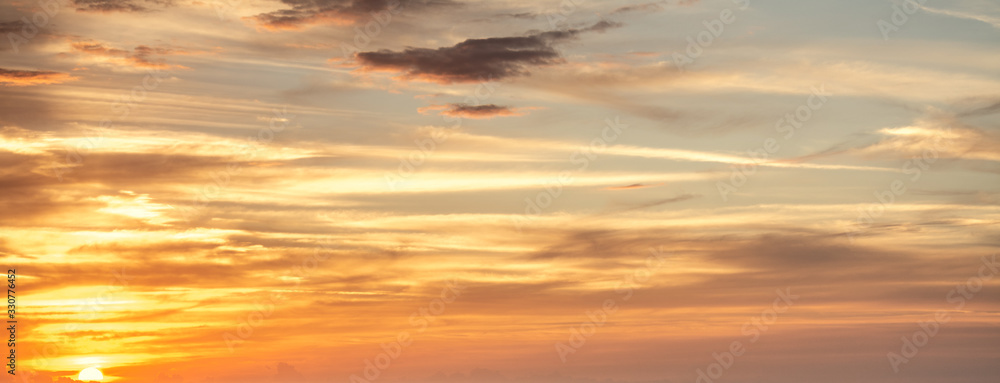Orange sky with clouds at sunset in Sardinia