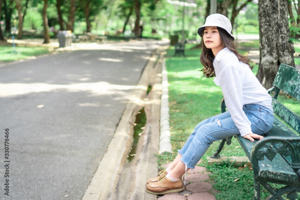  Beautiful Asian women with long hair wearing a white shirt. White bug hat, jeans showing emotions In the nature park-09.jpg, Asian beautiful woman with yellow skin, long black hair, wearing a white s