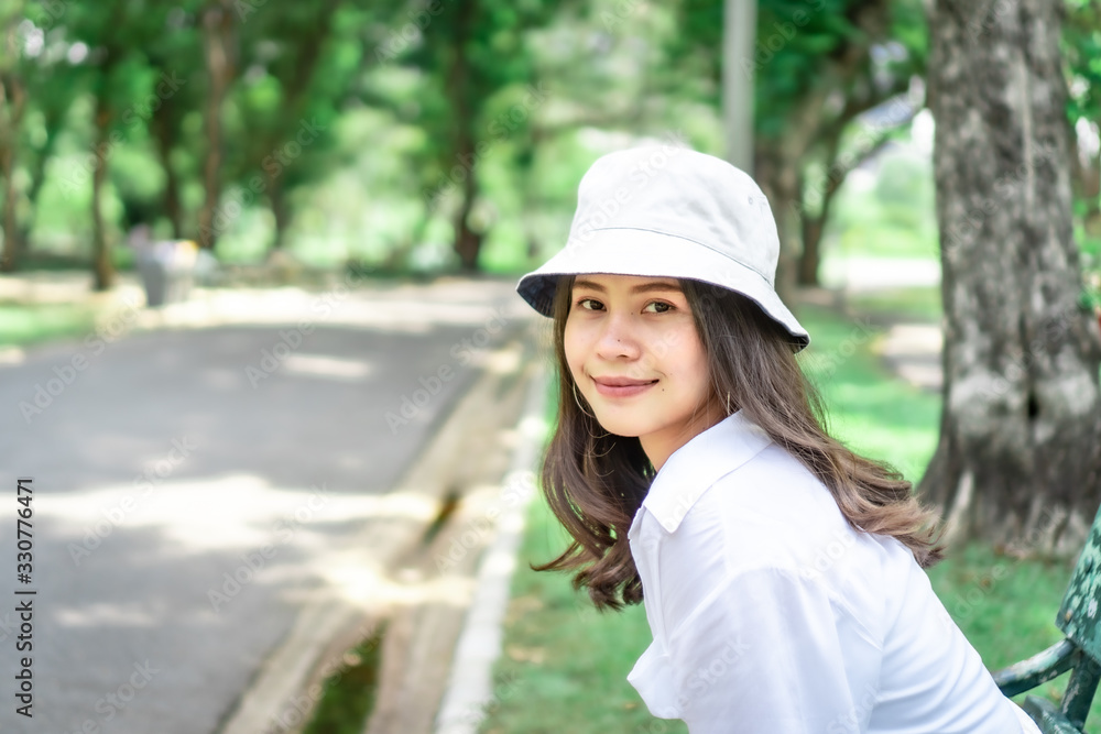  Beautiful Asian women with long hair wearing a white shirt. White bug hat, jeans showing emotions In the nature park-09.jpg, Asian beautiful woman with yellow skin, long black hair, wearing a white s