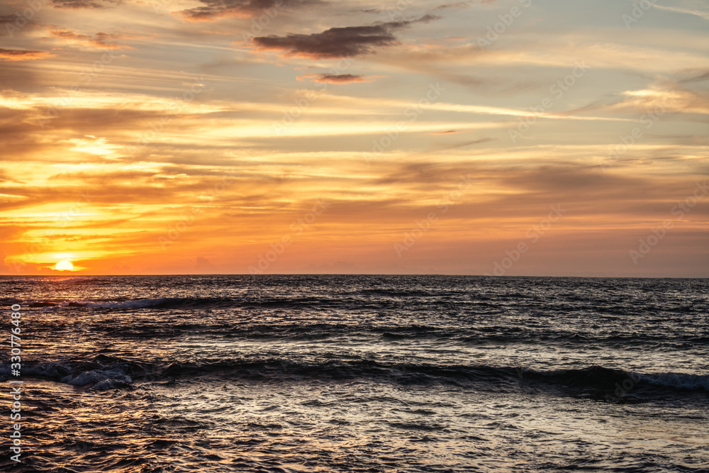 Fototapeta premium Cloudy sky over Porto Ferro at sunset