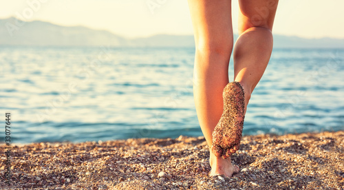 Legs on tropical sand beach. © Cherries