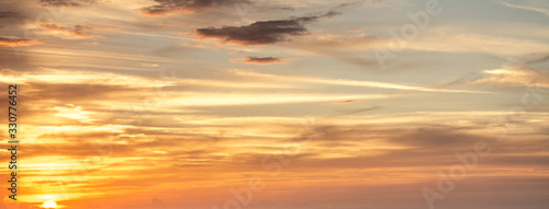 Orange sky with clouds at sunset in Sardinia