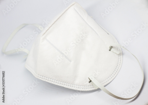 Fototapeta Naklejka Na Ścianę i Meble -  White n95 mask protect filter against air pollution (PM2.5) on white background, wearing a mask to prevent viruses and bacteria