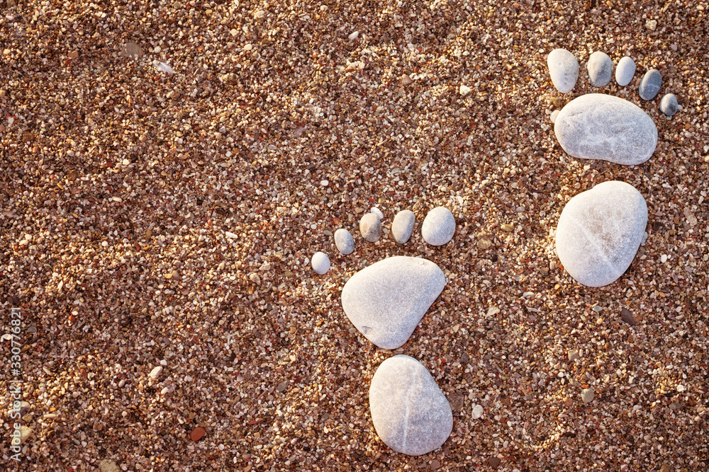 Happy feet. Stone arranged like a footprint on the stony beach Happy feet. Stone arranged like a footprint on the stony beach