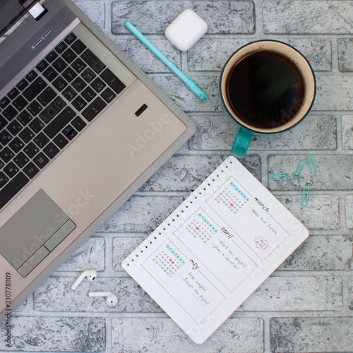 Concept layout of work place. Notebook, planner and a cup of coffee on a stone background
