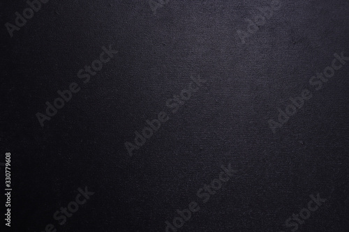 Black textured background with a gradient.
