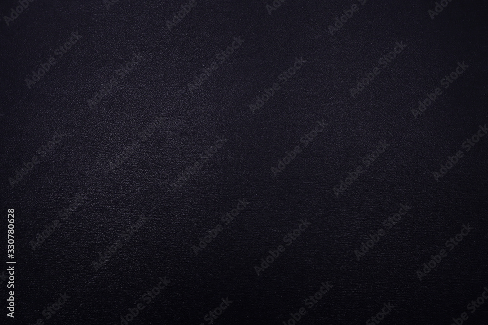 Black textured background with a gradient. Black textured background with a gradient.