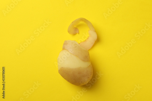 Young potato on yellow background, space for text photo