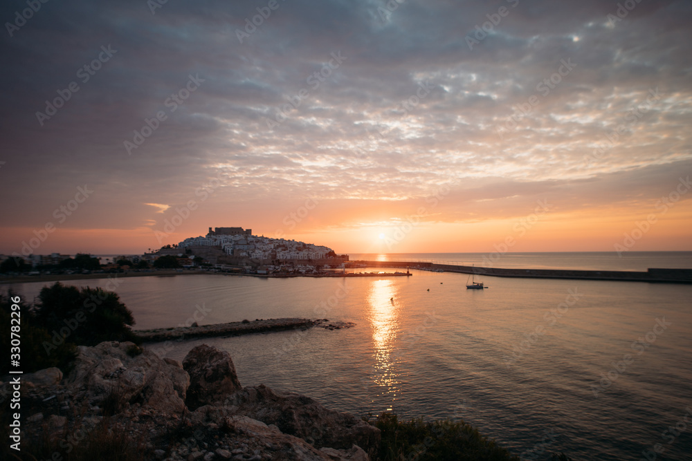 sunrise on the background of the castle of Peniscola, Spain