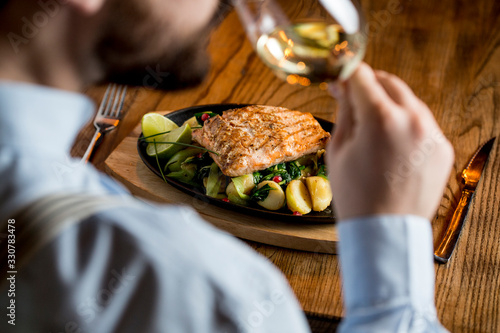 Young man eating salmon fil...