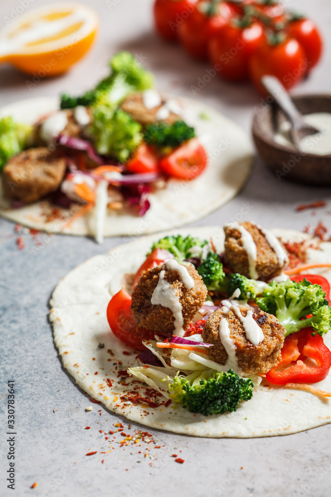 Falafel with pita, vegetables and tahini dressing. Falafel with pita, vegetables and tahini dressing.