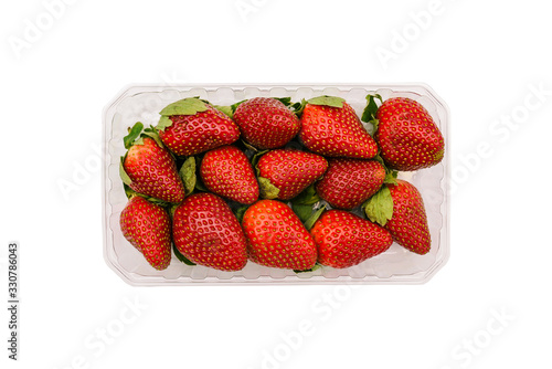 Plastic container with strawberries isolated on a white background. Fresh and ripe summer berries in the package. Top view, flat lay.