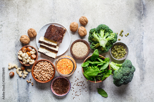 Vegan sources of protein  background  top view. Tofu  chickpeas  lentils  nuts  spinach and broccoli - vegetable proteins.