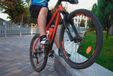 man on a bicycle, athlete travel, bike tricks, bicycle closeup orange, pedals contacts, shoes, clothing for a cyclist