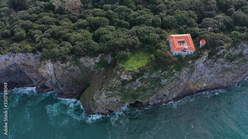 San Emeterio Lighthouse, Landscape in the surroundings of the cave of the Pindal, lighthouse and hermitage of San Emeterio, Cantabrian Sea, Asturias, Spain, Europe photo