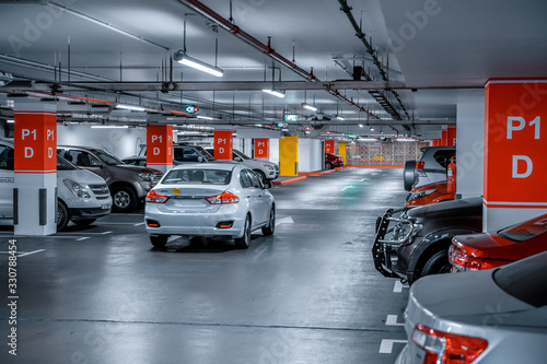 Parking garage - interior shot of multi-story car park, underground parking with cars