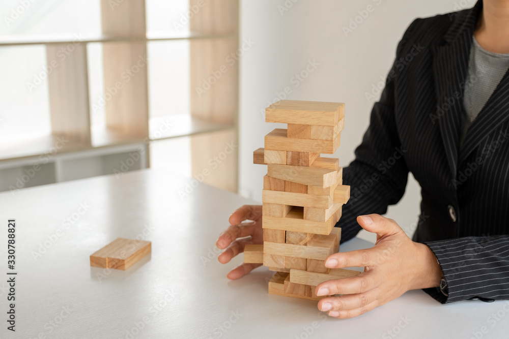 Hand holding blocks wood game, Concept Risk of management and strategy plan, growth business success process and team work Hand holding blocks wood game, Concept Risk of management and strategy plan, growth business success process and team work