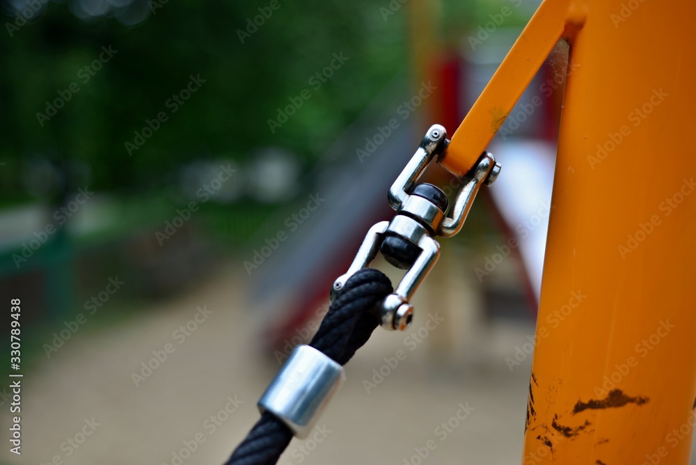 Anchoring of the rope to the steel structure. Rope clutch. Anchoring the structure on the playground.