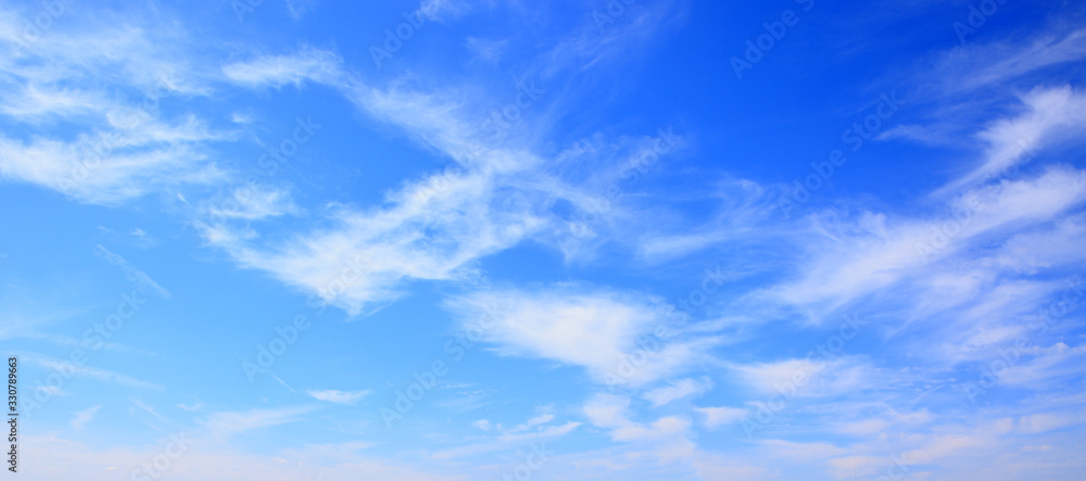 Fototapeta premium Blue sky background with tiny clouds.