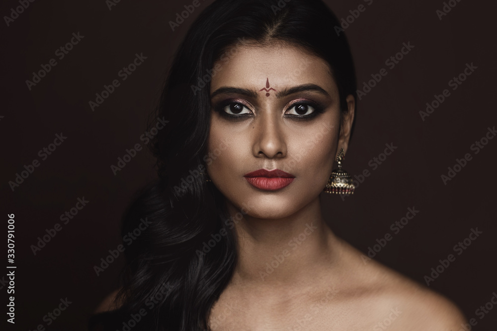 Portrait of Indian woman with beautiful makeup and hairstyle on brown  background Stock Photo | Adobe Stock
