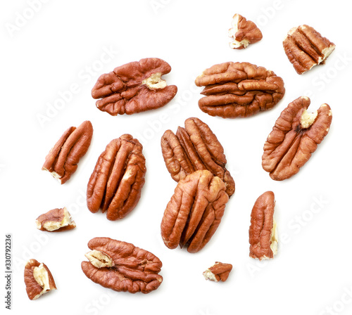 Peeled pecans with broken halves and pieces on a white background. The view from top. photo