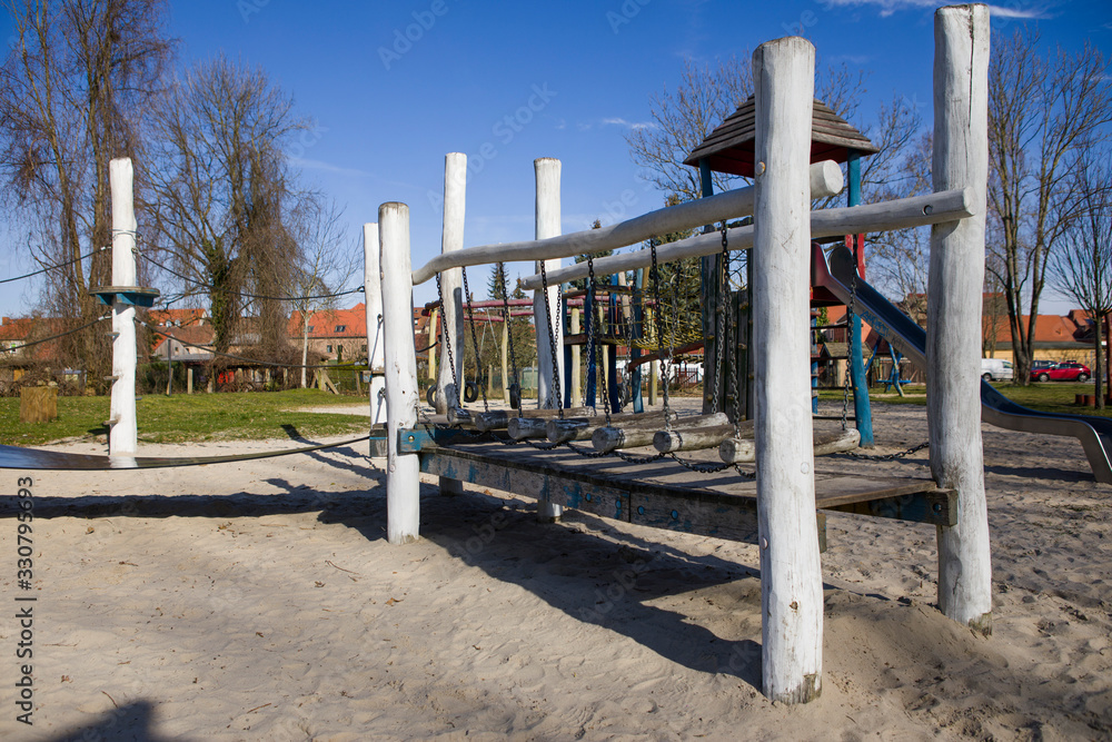 An empty playground with a swing in a natural environment An empty playground with a swing in a natural environment