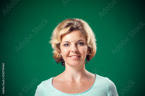 A portrait of smiling woman looking at camera. People and emotions concept