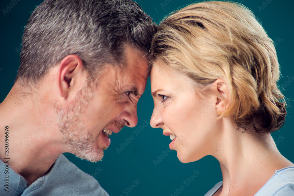 A portrait of angry couple staying face to face. People and emotions concept A portrait of angry couple staying face to face. People and emotions concept