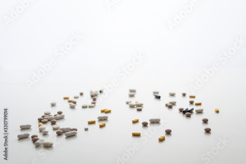 White background with scattered tablets. Bright medical background. Copy space. Minimal composition. Isolated.