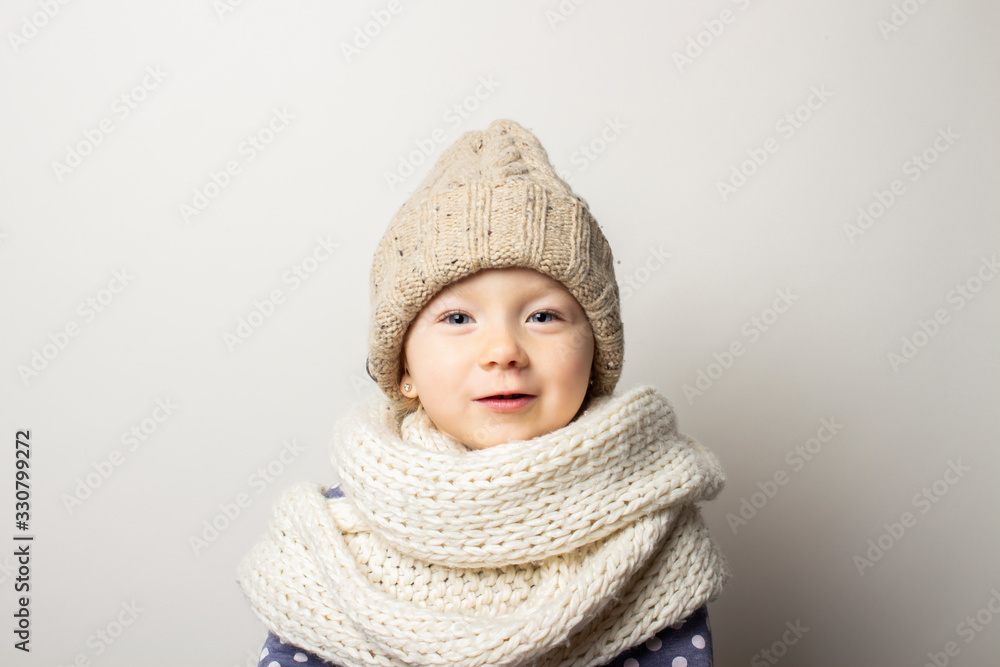 beautiful little baby in a hat on a light background. Concept of children's emotions, winter, shopping beautiful little baby in a hat on a light background. Concept of children's emotions, winter, shopping