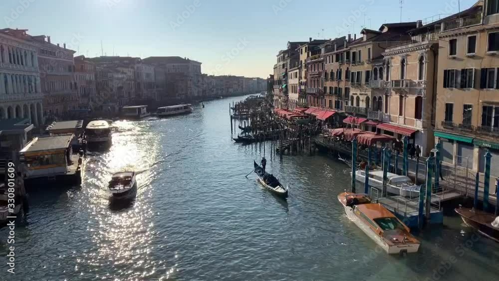 VENICE, ITALY - JANUARY 21, 2020. Boats in Venice Grand canal. Italy winter travel, bridge and houses. Romantic destination in Europe. VENICE, ITALY - JANUARY 21, 2020. Boats in Venice Grand canal. Italy winter travel, bridge and houses. Romantic destination in Europe.